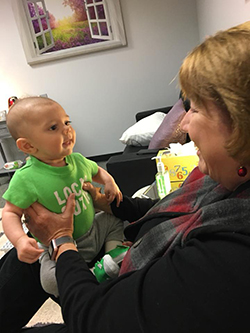 Michele Rogers doing what she loves best— playing with babies!